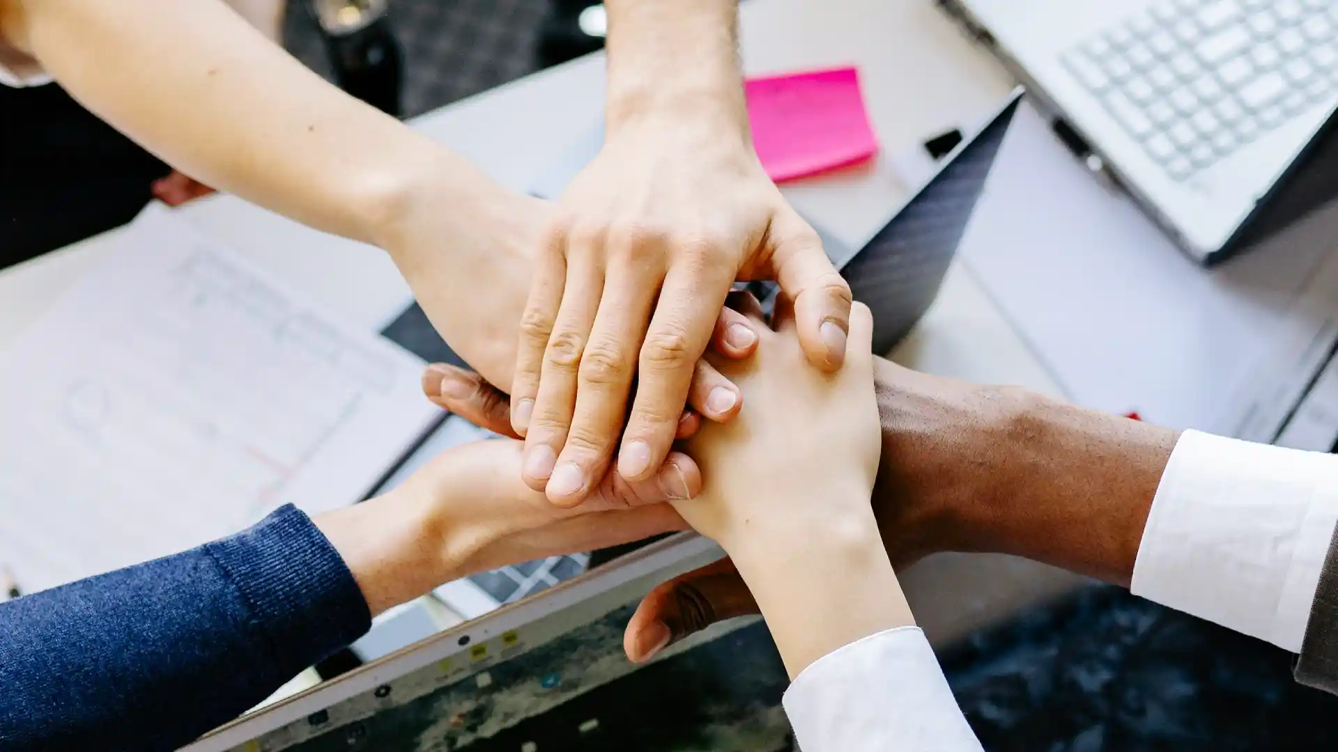 A group of people stacking hands